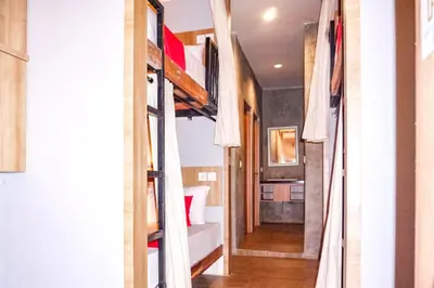 a bedroom with bunk beds in a room at RedDoorz Hostel Near Ngurah Rai Airport Kuta in Kuta