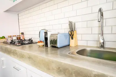 a kitchen counter with a sink and a microwave at Casa Su Seminyak in Seminyak