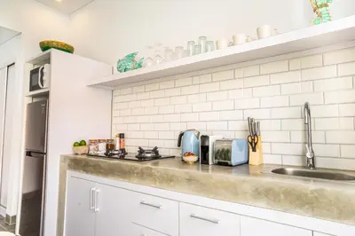 a kitchen with a sink and a counter top at Casa Su Seminyak in Seminyak