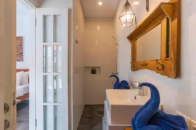 a bathroom with a sink and a mirror at Casa Nisa Seminyak in Seminyak