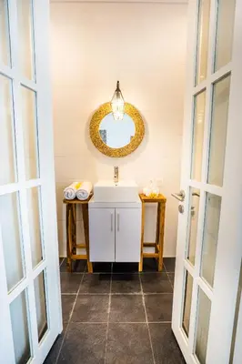 a bathroom with a sink and a mirror at Casa Ku Seminyak in Seminyak