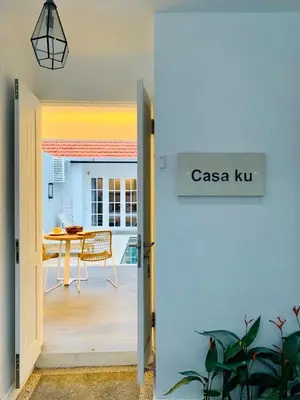 a door leading into a dining room with a table at Casa Ku Seminyak in Seminyak