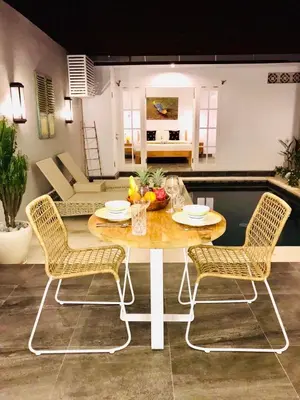 a dining room with a table and two chairs at Casa Ku Seminyak in Seminyak