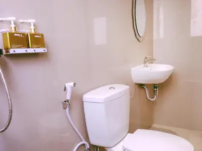 a bathroom with a toilet and a sink at Kuta Sari House in Kuta
