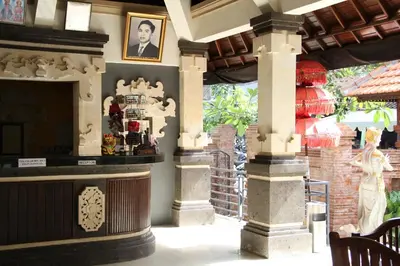 a museum with a statue of a man on a wall at Troppo Zone Puri Rama Resort Kuta in Legian