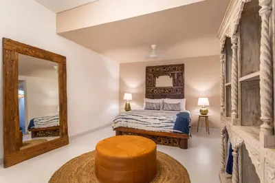 a bedroom with a bed and a mirror at PinkPrivate Sanur - for Cool Adults Only in Sanur