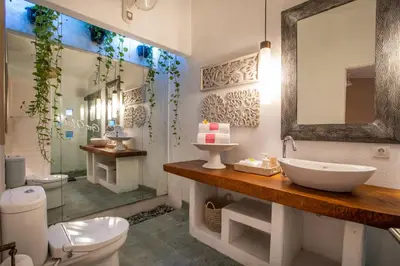 a bathroom with a sink and a toilet and a shower at PinkPrivate Sanur - for Cool Adults Only in Sanur