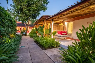 an outdoor patio with a bench and plants at PinkPrivate Sanur - for Cool Adults Only in Sanur