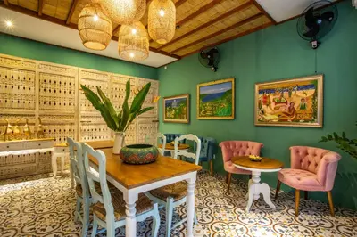 a dining room with green walls and a table and chairs at PinkPrivate Sanur - for Cool Adults Only in Sanur
