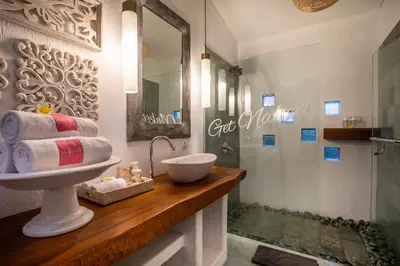 a bathroom with a sink and a shower at PinkPrivate Sanur - for Cool Adults Only in Sanur