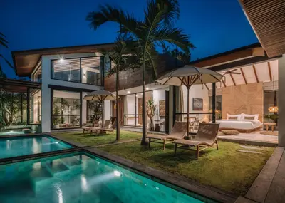a villa with a swimming pool and a bedroom at Beyond Bespoke Villas in Seminyak