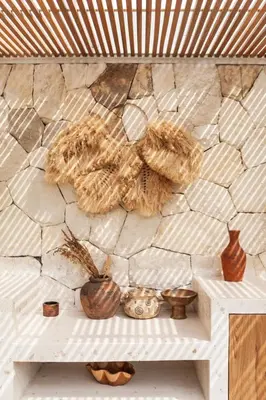 a stone wall with vases sitting on a shelf at Beyond Bespoke Villas in Seminyak