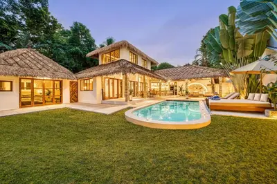 an exterior view of a house with a swimming pool at Villa Barcelona - Private 6 BDR Brand New Villa in Seminyak, Best Location, large Pool & Garden in Seminyak