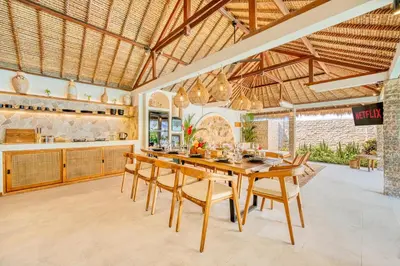 an open kitchen and dining room with a wooden table and chairs at Villa Barcelona - Private 6 BDR Brand New Villa in Seminyak, Best Location, large Pool & Garden in Seminyak