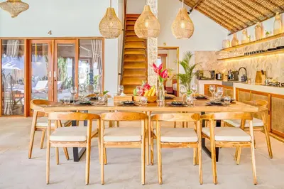 a dining room with a wooden table and chairs at Villa Barcelona - Private 6 BDR Brand New Villa in Seminyak, Best Location, large Pool & Garden in Seminyak