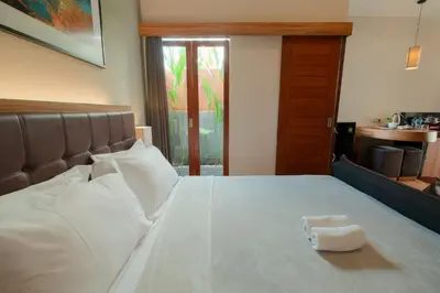 a bed with a white towel on top of it at Andewi Guest House Denpasar RedPartner - Minimum Stay 30 Nights in Sanur