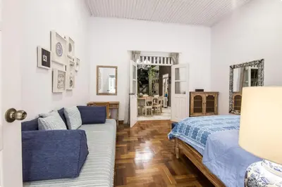 a bedroom with a bed and a couch at Villa Alexandra Seminyak By Island Escape in Seminyak