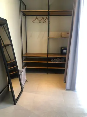 a dressing room with a mirror and a closet at Rumah Kahyangan in Canggu