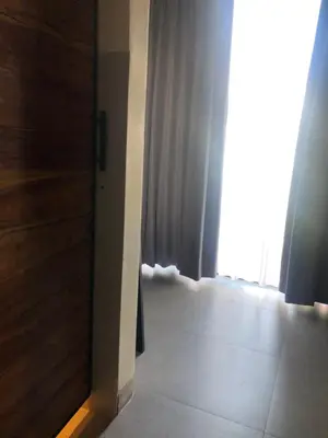 an open door to a room with a window at Rumah Kahyangan in Canggu