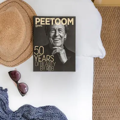 a magazine on a wall next to a hat at MAMAKA by Ovolo in Kuta