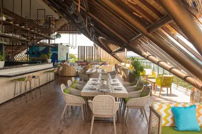 a restaurant with tables and chairs in a building at MAMAKA by Ovolo in Kuta