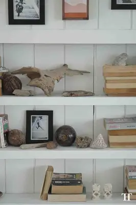 a shelf with a bird sculpture and books on it at THE HIDDEN TREE CANGGU 100 meter to beach in Canggu