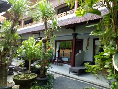 a view of the courtyard of a house with palm trees at Taman Ayu Legian Hotel in Legian