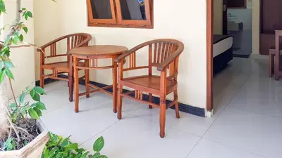 two chairs and a table in a room at KoolKost at Poppies Lane Street - Minimum stay 30 nights in Denpasar
