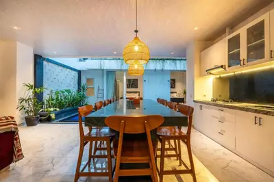 a kitchen with a dining room table and chairs at La Terra Villas Canggu Kuta Bali in Canggu