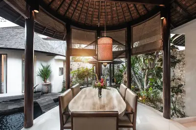 a dining room with a table and chairs at Sandi Kala Villas in Kerobokan