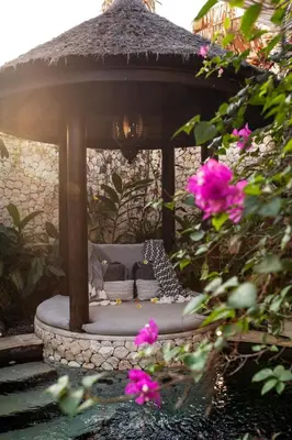 a gazebo with a cat sitting in it at Sandi Kala Villas in Kerobokan