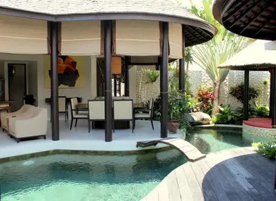 a swimming pool in a backyard with a house at Sandi Kala Villas in Kerobokan