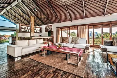 a living room with a couch and a table at Villa De Jiwa 495 Seminyak in Seminyak