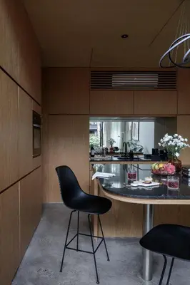 a kitchen with a black chair and a table at OXO Townhouses Umalas - Close to Seminyak & Canggu in Seminyak