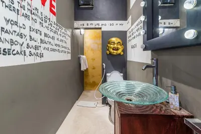 a bathroom with a sink with a mask on the wall at Saga Villas ULTRA in Seminyak