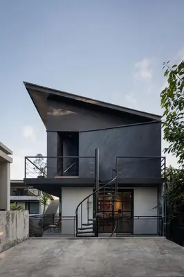 a modern house with a black roof at T Lofts in Seminyak