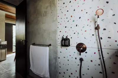 a bathroom with a wall with hearts on the wall at T Lofts in Seminyak