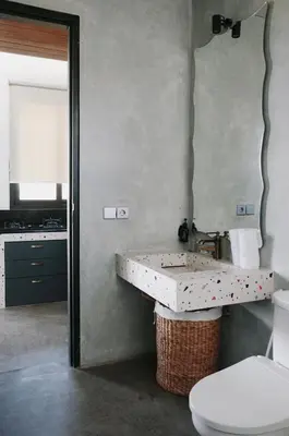 a bathroom with a sink and a toilet and a mirror at T Lofts in Seminyak