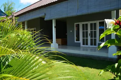 a house with a white door and some plants at Villa Eden Seminyak in Seminyak