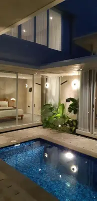 a house with a swimming pool in a room at Villa Teejay - architect-designed luxury in perfect Petitenget location in Seminyak