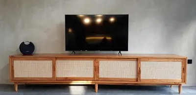 a television sitting on top of a wooden entertainment center at Villa Teejay - architect-designed luxury in perfect Petitenget location in Seminyak