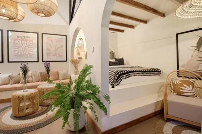 a living room with a bed and a table at Seminyak Beach Bungalow Studio Villa 1 with private pool SBB1 in Seminyak