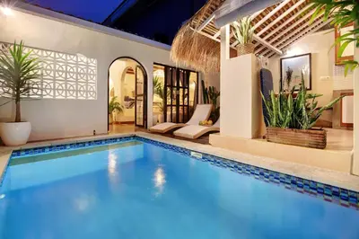 a swimming pool in a villa with a house at Seminyak Beach Bungalow Studio Villa 1 with private pool SBB1 in Seminyak