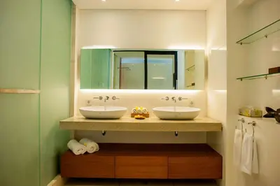 a bathroom with two sinks and a mirror at Villa Muse Seminyak - 500 meters from beach in Seminyak