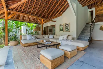 a living room with a couch and a table at Tropical 5BR Villa & 20m Pool, Sleeps 12 in Seminyak