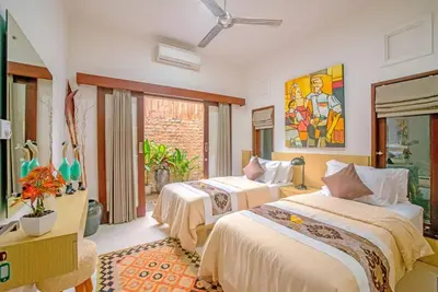 a bedroom with two beds in a room at Villa Ellen in Seminyak