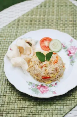 a plate of food with rice and vegetables on a table at RakaAyu Kuta in Kuta