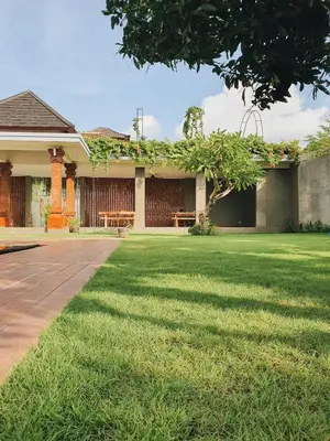 a house with a lawn in front of it at RakaAyu Kuta in Kuta