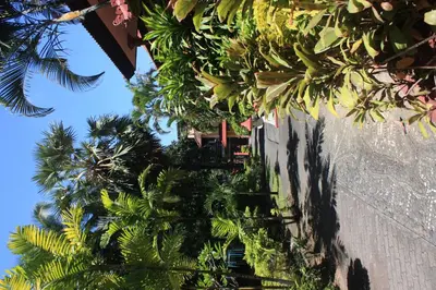 a building with plants on the side of it at Puri Naga Beachfront Cottages in Legian