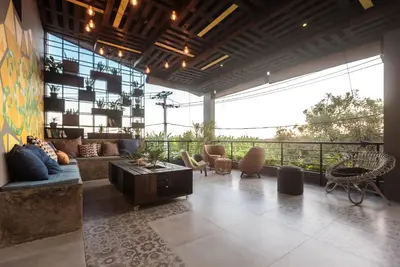 a large living room with a couch and a table at 7Rooms Villa Seminyak in Seminyak